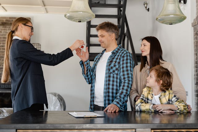 a landlord handing new keys over to tenants